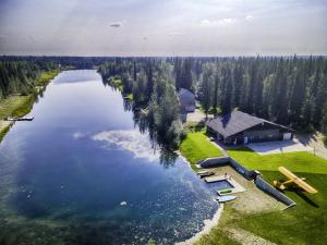 an aerial view of a large lake with a house at Lakefront Aviators Aurora Retreat in North Pole