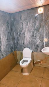 a bathroom with a toilet and a sink at THANAL homes in Kollam
