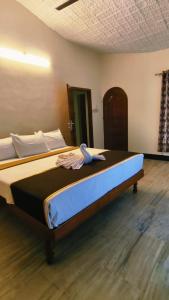 a large bed sitting in a room with at THANAL homes in Kollam