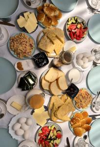 a table with many plates of food on it at Eka's guest house in Mestia +13 photos