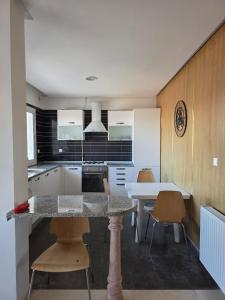 a kitchen with a table and chairs in a room at luxurious two bedroom appartement in Hiboun