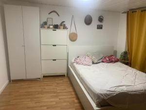 a small bedroom with a bed and a dresser at Köpenick spree 1 bed room house in Berlin