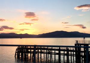 a dock on a body of water at sunset at Lochview at 33a in Gourock