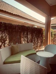 a patio with a couch and two chairs and a table at Nehema Appartments in Lubumbashi