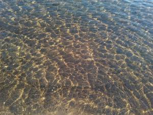 a close up of the sand in the water at Grandes Apartments Kouremenos in Palekastron