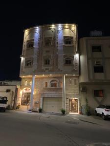 a large building with lights on it at night at كازا in Taif