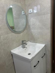 a bathroom with a sink and a mirror at МилаДэя in Kapchagay