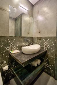 a bathroom with a sink and a mirror at The Goa Courtyard by Forever stays in Arpora +102 photos