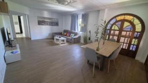 a living room with a table and a couch at The Simpsons in Seville in Mairena del Aljarafe