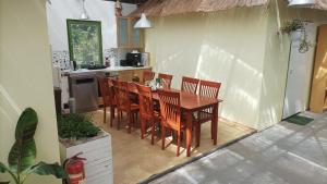 a kitchen with a wooden table and chairs at Tree Tent Bratislava in Prievoz +18 photos
