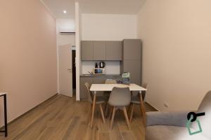 a kitchen and dining room with a table and chairs at Collegno Cozy Apartments in Turin