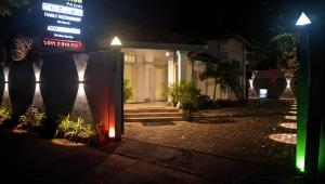 a sign in front of a building at night at Sahansa hotel in Nugegoda +5 photos