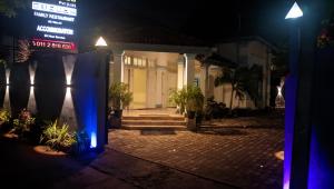 a building with blue lights on a street at night at Sahansa hotel in Nugegoda