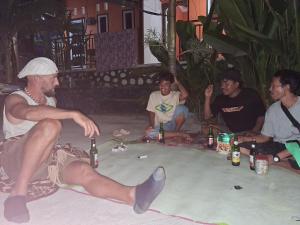 a group of men sitting in a hot tub with beer at Teman Homestay in Kuta Lombok +24 photos