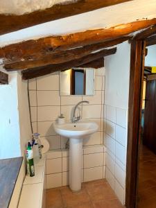 a bathroom with a sink and a mirror at Albergue OasisTrails for pilgrims on Camino de Santiago in Villamayor de Monjardín +75 photos