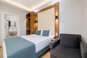 a bedroom with a large bed and a couch at Hotel Black Tulip in Istanbul +34 photos