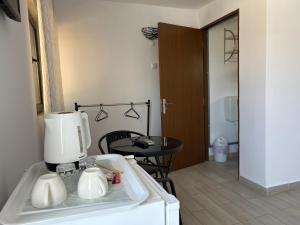 a kitchen with a coffee maker on top of a sink at Vila Elna in 2 Mai