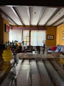 a living room with a table and a couch at Casa Nectarius in Cifuentes