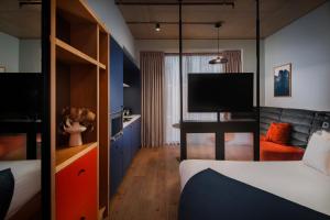 a hotel room with a bed and a tv at Beckett Locke in Dublin