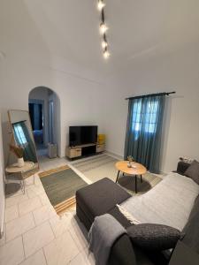 a living room with a couch and a tv at Anassa Homes Leros in Agia Marina