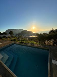 a swimming pool with the sunset in the background at Casa Tiberius Capri Retreat by Sweet Capri in Capri