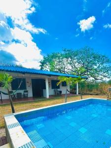 a villa with a swimming pool in front of a house at Cabana Steps From The Beach - Pool & Beach Access in Nueva Gorgona