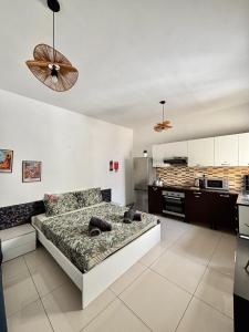 a living room with a bed and a kitchen at Private Room and Own Kitchen Steps to Beach & Nightlife in Sliema