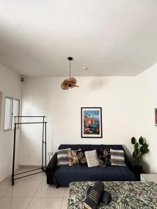 a living room with a couch and a bed at Private Room and Own Kitchen Steps to Beach & Nightlife in Sliema