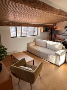 a living room with a couch and a chair at Le petit nid Aixois in Aix-en-Provence +1 photo
