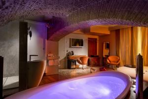 a bathroom with a bath tub in a room at SuiteSistina for Brave Lovers in Rome +62 photos