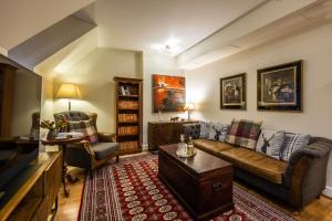 a living room with a couch and a table at Moat House 8 Harris Apartment in Fort Augustus