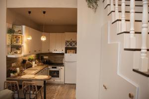 a kitchen with white cabinets and a table at Chryso Boutique Guesthouse in Chrysoupolis