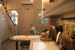 a room with two tables and a staircase at Chryso Boutique Guesthouse in Chrysoupolis +24 photos