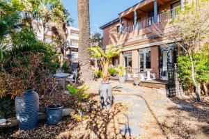 a house with a courtyard with potted plants at Albatross Guest House Bantry Bay in Cape Town