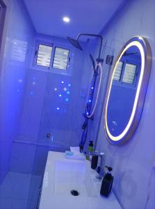 a bathroom with a sink and a mirror at Villa Harmonie - Suite Familiale avec Piscine in Khemisset