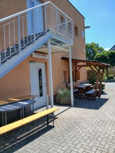 a building with a staircase and a patio at Pension Küfner in Markkleeberg