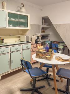 a kitchen with a table and chairs and a staircase at AviStar by Portus Alacer in Avis