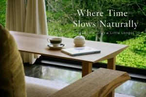 a coffee table with two cups and a book at Nakao Kogen Hotel Kazaguruma in Takayama