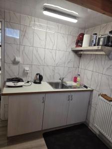 a kitchen with a sink and a counter top at Poddasze in Zblewo