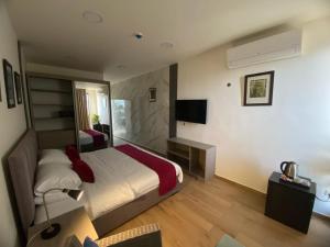 a hotel room with a bed and a television at Sindyan Resort in Al Salt