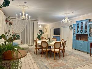 a living room with a dining room table and chairs at Comfort Villa Sheki in Sheki