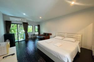 a bedroom with a large white bed and a window at Fairtex Residence Pattaya in North Pattaya +105 photos