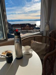 a table with a thermos and a plate of food on it at Refugio del Sur in San Carlos de Bariloche
