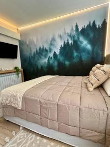a bedroom with a large bed with a painting on the wall at Refugio del Sur in San Carlos de Bariloche