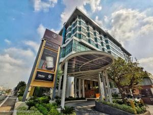 a large building with a sign in front of it at Siam Mandarina Hotel - Free BKK Airport Shuttle in Lat Krabang