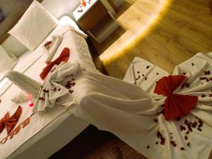 two beds in a room with a dress on them at Ada Apart Hotel in Antalya