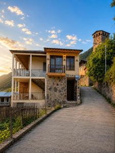 a house on a hill with a driveway at Eka's guest house in Mestia