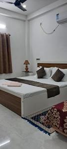 a bedroom with two beds and a table at Diya Homestay in Rāmpur Hāt