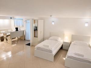 a bedroom with two beds and a desk and a piano at Ferienwohnungen Domblick-Herkenrath in Bergisch Gladbach