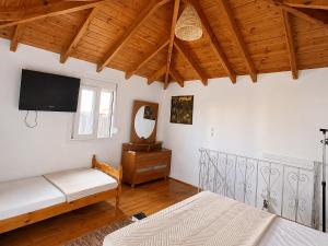 a living room with two beds and a tv at Bella Casa Lydia - Peaceful Retreat in Rhodes in Rhodes Town